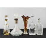 Four glass decanters of differing style and form, and a Carnival glass vase.