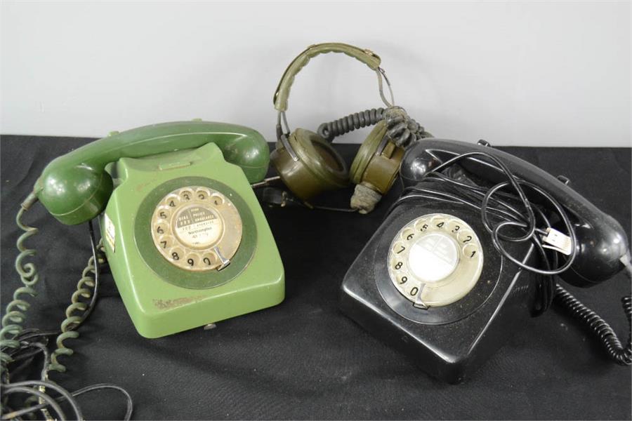 A black bakelite and green bakelite telephone and RAF headset.