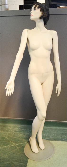 A female full size shop mannequin.