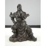 A Chinese carved figure of a warrior, 25cm high.