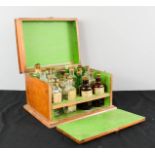 A 19th century mahogany chemists box, with green paper lined interior, containing original bottles.
