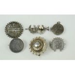 A group of silver brooches including sweetheart and Victorian examples.