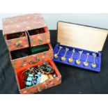 A jewellery box containing costume jewellery and a set of novelty coffee spoons.
