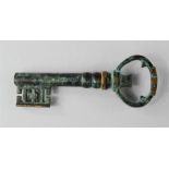 A bronze green patinated key form bottle opener.