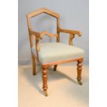 An Arts & Crafts oak armchair, with upholstered seat.