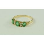 A 14ct emerald and diamond ring. 2.2g.