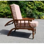 An elm reclining chair with retractable spindle back.