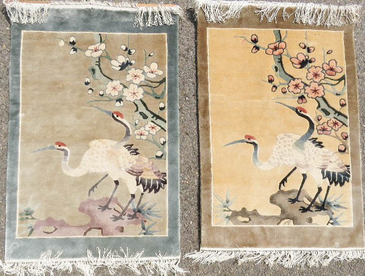 A pair of silk rugs, depicting cranes.