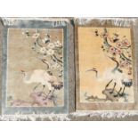 A pair of silk rugs, depicting cranes.