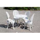 A cast metal garden set comprising table and chairs, painted white.