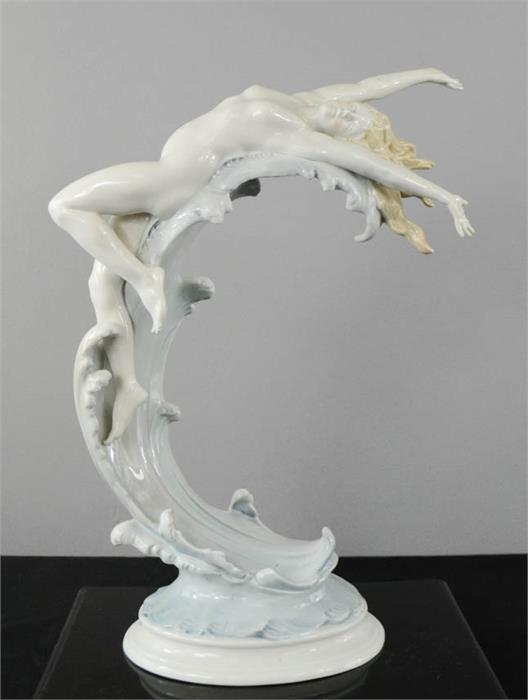 A Kunstporzellane Metzler & Ortloff porcelain figure of a woman on the crest of a wave, 35cm high.