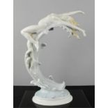 A Kunstporzellane Metzler & Ortloff porcelain figure of a woman on the crest of a wave, 35cm high.