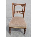 An Edwardian chair with upholstered base.