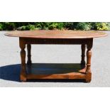 An oak oval top coffee table with undershelf. 54 by 119 by 81cm.
