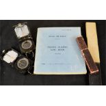An RAF flying log book, two compasses, and a rule.