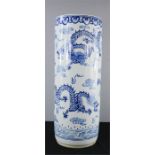 A Chinese blue and white umbrella stand, depicting dragons, 61cm high.