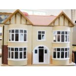 A large dolls house together with dolls house furniture.