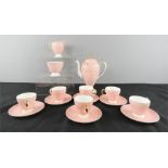 A Wedgwood china tea service in peach, six cups and saucers, sugar bowl and tea pot.