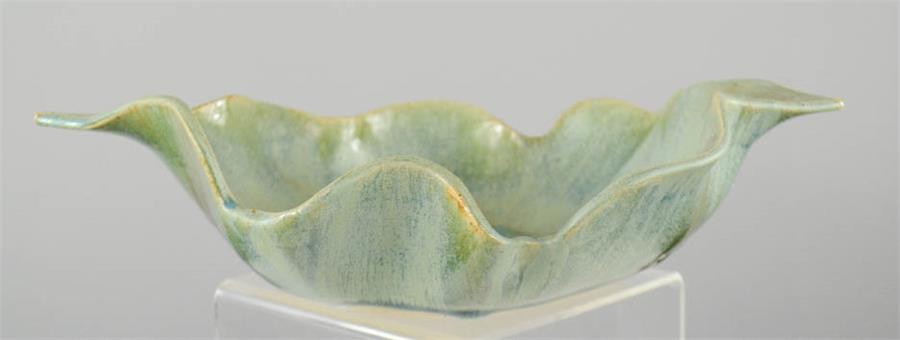 A Studio Pottery leaf form bowl with slip glazed oxidised finish, impressed with monogram.