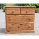 A small pine chest of drawers.