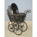 A wicker child's bentwood pram, with doll.