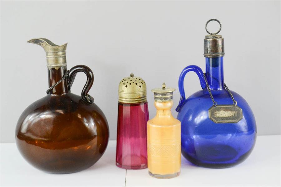 A group of antique glassware to include a blue glass bottle bearing Brandy tag, a brown glass bottle