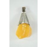 An amber and silver pendant.