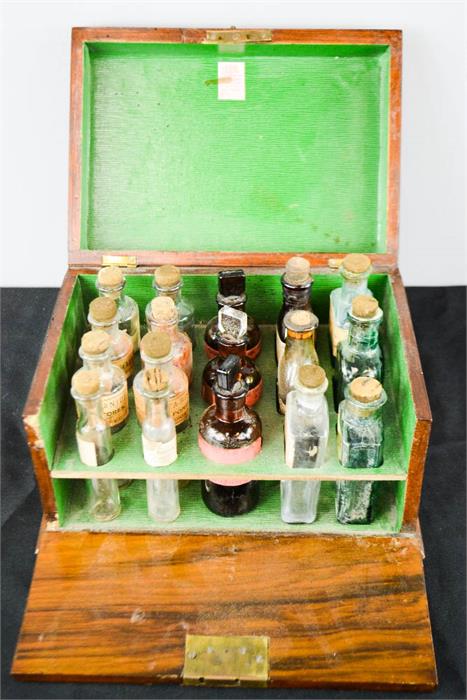 A 19th century chemists box in rosewood, green paper lined interior, containing original bottles