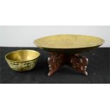A Chinese brass dish on stand and a brass bowl engraved with decoration.