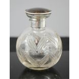 A silver glass and tortoiseshell perfume bottle.