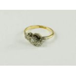 An 18ct gold and platinum ring with three small diamonds, 3.2g.