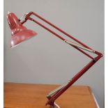 A clamp anglepoise lamp, in red.