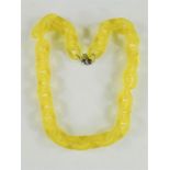 A plastic retro yellow chain necklace.