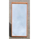 A Danish teak wall mirror, 80 by 36cm.