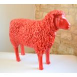 A life-size model sheep in red, 60 by 72 by 23cm.