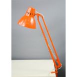 An Isa anglepoise clamp lamp, in orange.