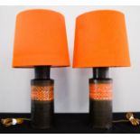 A pair of Italian Bitossi pottery table lamps, with original orange/red shades circa 1960.