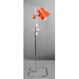 A red and chrome floor lamp in the manner of Anders Pehrson.