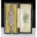 An Art Deco silver and paste cocktail wristwatch, with the original box by Nathan & Co., 18.9g