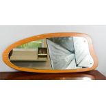 A shaped teak wall mirror circa 1950.