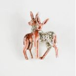 A retro brooch depicting two enamelled deer.