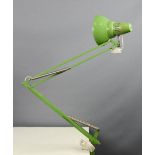 A Luxo anglepoise clamp lamp, in green.