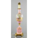 A French hand painted lamp base depicting a lovers scene signed E Carelle, with pink ground and gilt