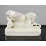 A Belleek porcelain hippocampus and shell form trinket holder, 12cm high.