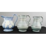 Three Victorian jugs, one with blue ground decorated with raised grape and vine, together with two