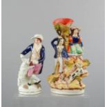 Two Staffordshire figure groups; posy holder depicting a man and woman and dogs to the fore, and a