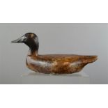 A naive treen carved duck, bearing residual paintwork.