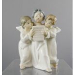 A Lladro group of choir angels, 17cm high.