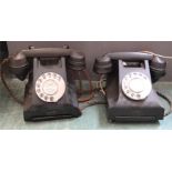 Two bakelite black telephones.