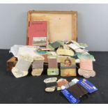 A wooden box containing old sewing patterns, transfers, wools and cottons etc.
